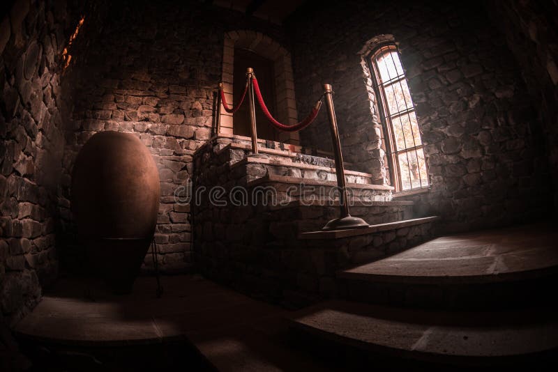 Inside of old creepy abandoned mansion. Staircase and colonnade. Dark castle stairs to the basement. Spooky dungeon stone stairs. In old castle. Horror stock photography