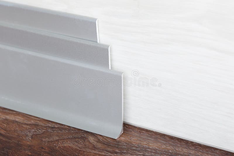 Installed skirting on the a wooden wall royalty free stock photography