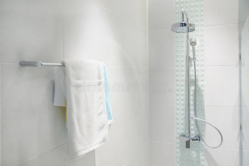 Interior of bathroom with modern shower head and white towel. At rail in bathroom royalty free stock images