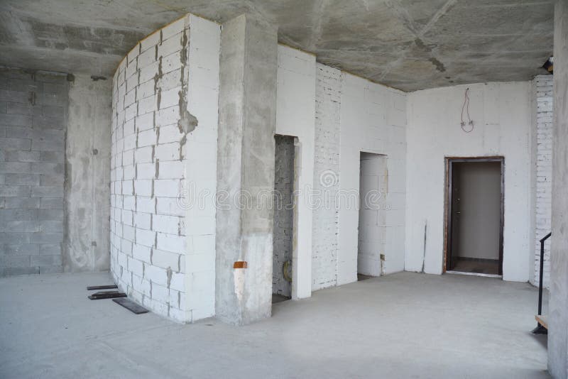 Interior hall room under construction, metal door lintels. Wall without plasterwork and ready to remodel. Photo stock images