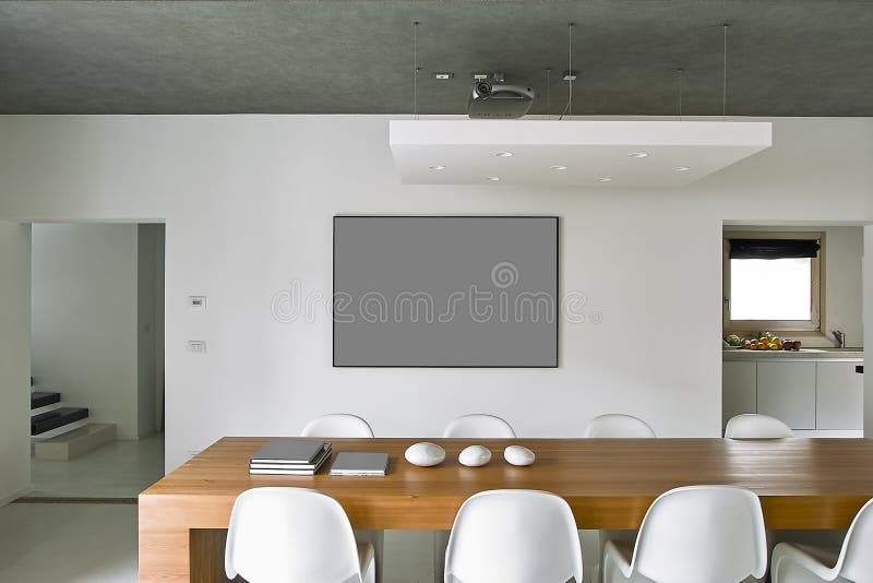 Interiors shots of a modern dining room i. N the foreground the dining table royalty free stock photo