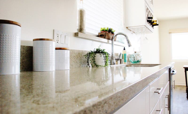 Kitchen Counter. Kitchen Granite Counter, plant, wine glasses, wine rack royalty free stock photo