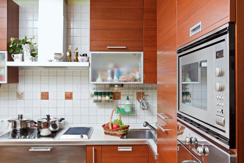 Kitchen interior with build in microwave oven. Part of Kitchen interior with wooden furniture and build in microwave oven royalty free stock photography