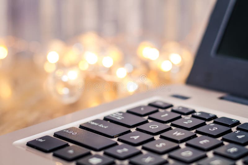 Laptop keyboard side view, selective focus, with gold tones and bokeh background, room for text copy. Business background technology stock images