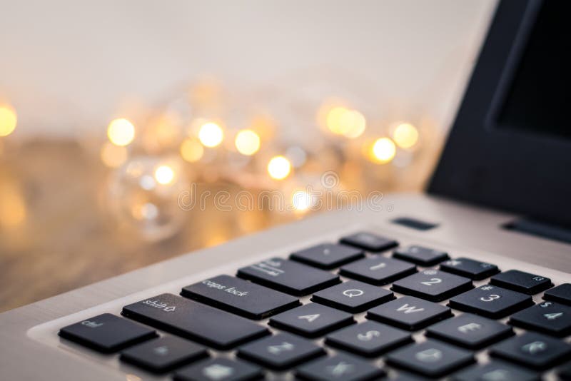 Laptop keyboard side view, selective focus, with gold tones and bokeh background, room for text copy. Business background technology royalty free stock image