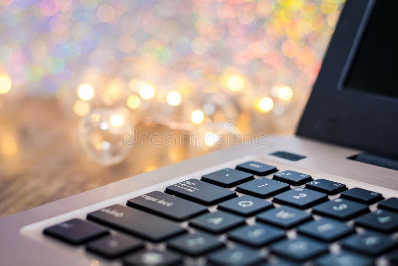 Laptop keyboard side view, selective focus, with gold tones and bokeh background, room for text copy. Business background technology royalty free stock images