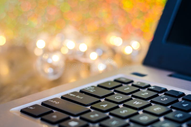 Laptop keyboard side view, selective focus, with gold tones and bokeh background, room for text copy. Business background technology royalty free stock photo