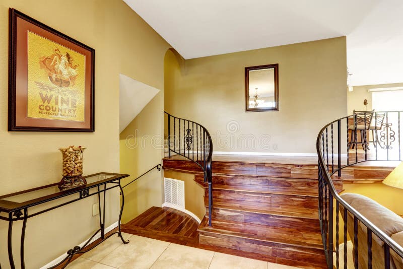 Large bright hallway interior design. Nice basement staircase. With metal railing and hardwood floor royalty free stock photography