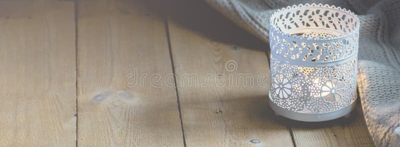 Long Banner for Home Interior Websites Lit Candle White Knitted Sweater on Plank Wood Table by Window. Cozy Winter Autumn Evening. Authentic Tranquil stock images