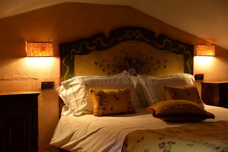 Luxury mountain hotel interior design. Sleeping room wooden furniture. Traditional mountain luxury hotel architecture. Sleeping room bed and stylish interior stock photo