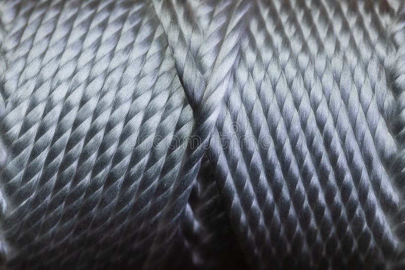 A macro of a spool of string wound in a very symmetrical pattern on a tube. The image is in very sharp focus and has a high royalty free stock image