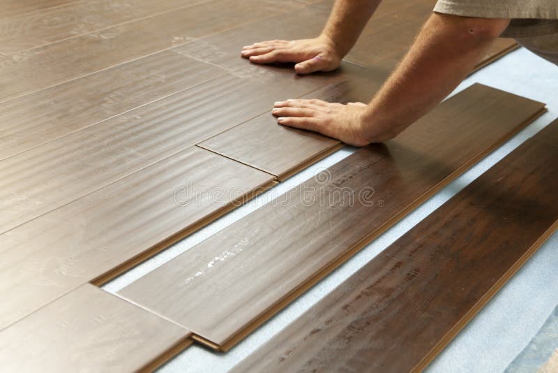 Man Installing New Laminate Wood Flooring stock photography