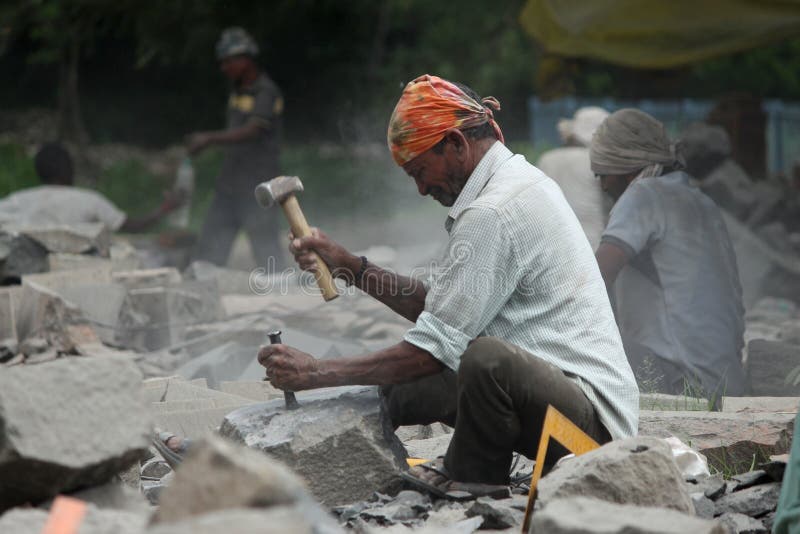 Man working on stone finishing for sculpture, Aurangabad. Maharashtra, India royalty free stock image