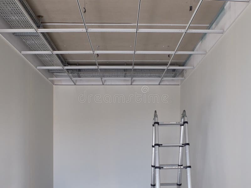 Metal frame of suspended ceilings and stepladder. Making of false ceilings.  royalty free stock images