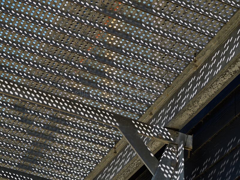 Metal stairs staircase with clear blue sky background. Metal stairs staircase made with small round holes for emergency entry exit with clear blue sky background royalty free stock images