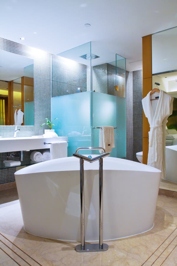 Modern bathroom. The fashion/modern bathroom, including bathtub, shower, basins and toilet stock image