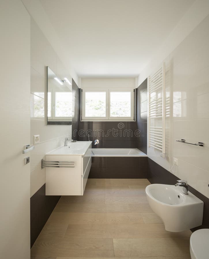 Modern bathroom with large dark tiles. Nobody inside stock photo