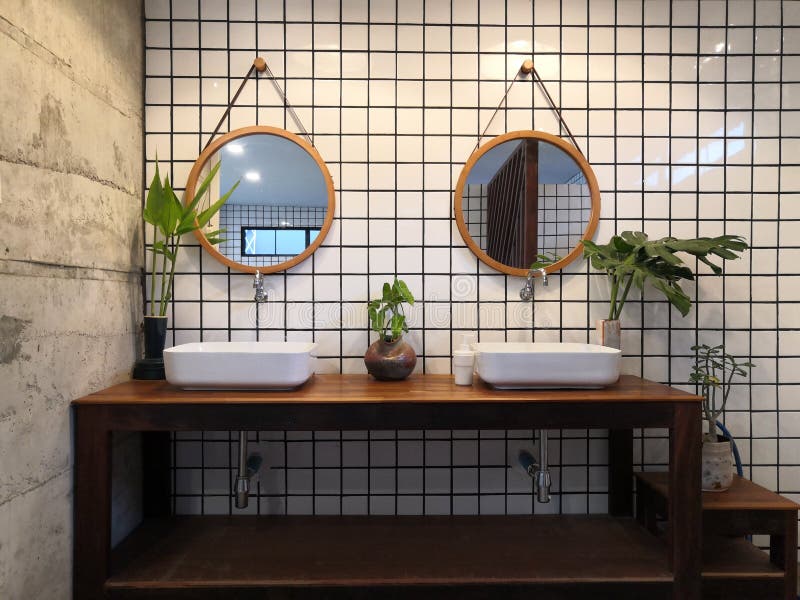 Modern Loft Bathroom interior design,white basin on wooden shelf with tile wall and a mirror. Concept stock photos