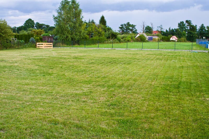 A house plot with well maintained grass and compost box in the corner stock photo