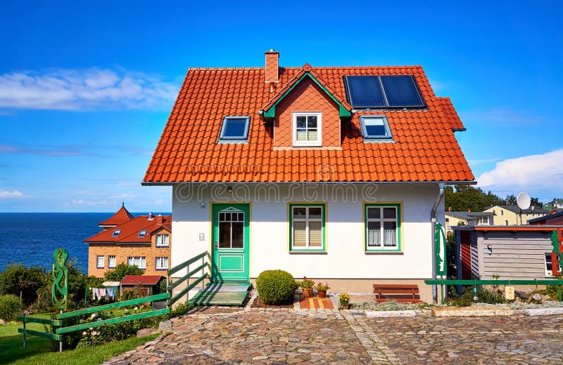 New modern single family house with red roof tiles and solar panels. Living overlooking the Baltic Sea on the island of Rügen. New modern single family house royalty free stock image
