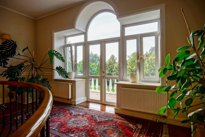 New pvc windows in old-styled interior stock images