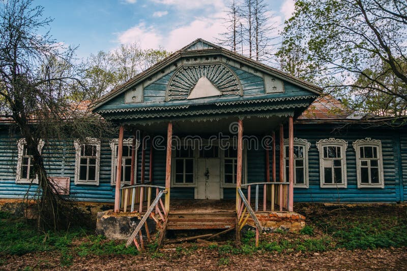 Old abandoned Russian rural house with wooden carved window frames.  royalty free stock image