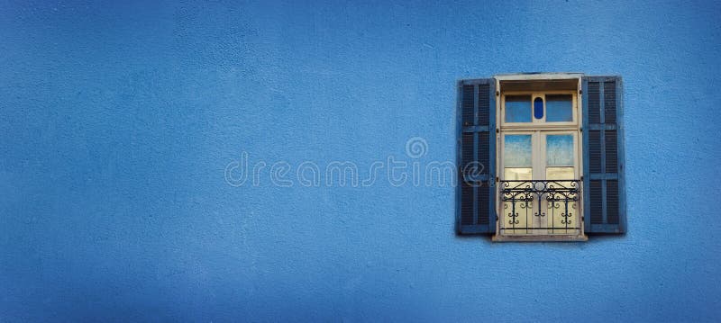 Old blue painted windows on concrete wall. Banner with copy space. Pop art concept, greek style window stock photography