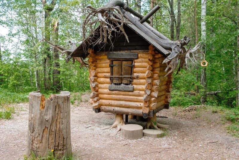 Old hut from Russian fairy tales in the woods in the summer. In a clearing in the forest mystical house stock photography