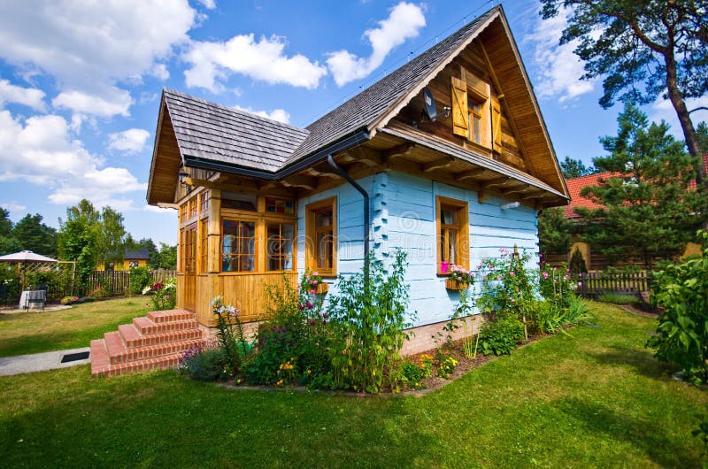 Wooden rural house in Poland, Roztocze region. An old, rural, classic wooden timber house in southern Poland, Roztocze region. Warm evening light, natural plants royalty free stock photography