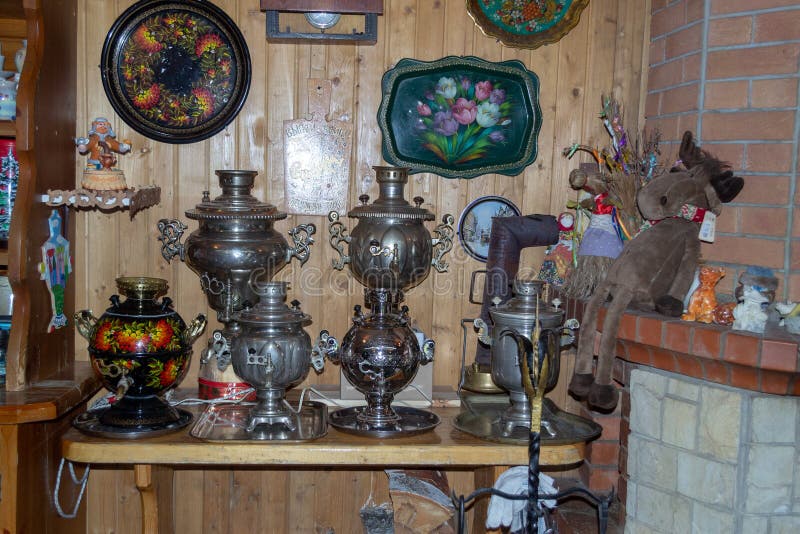 Old Russian village samovars and trays in the interior of a wooden house. Village house in Russia royalty free stock photo
