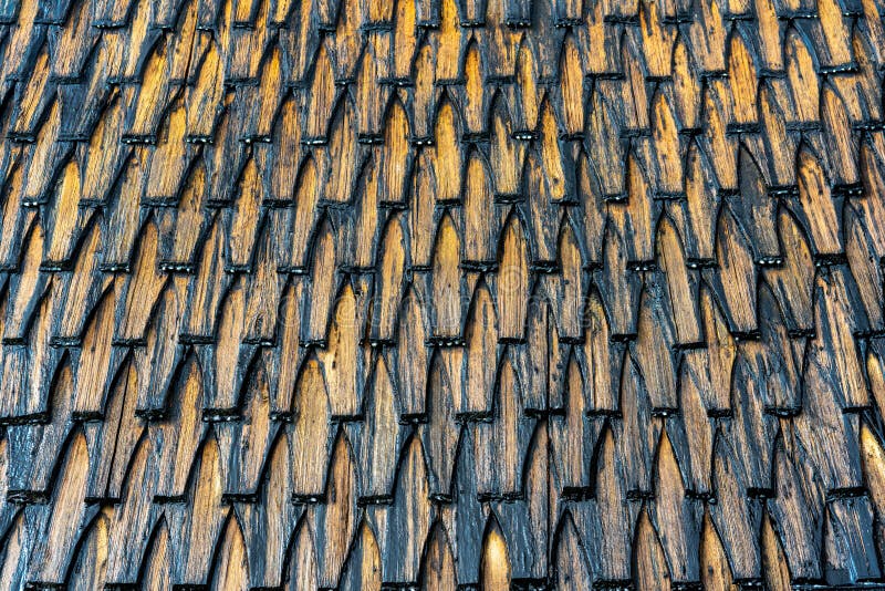 Old tared wooden roof with overlapped tile pattern royalty free stock photos
