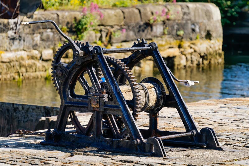 Old, vintage and rusted dam closing mechanism with cogwheels royalty free stock photography