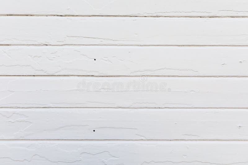 Old white wood planks on an old house wall. Newly painted. texture. Old planks on house wall with new paint. The old paint makes texture in the new paint stock photos