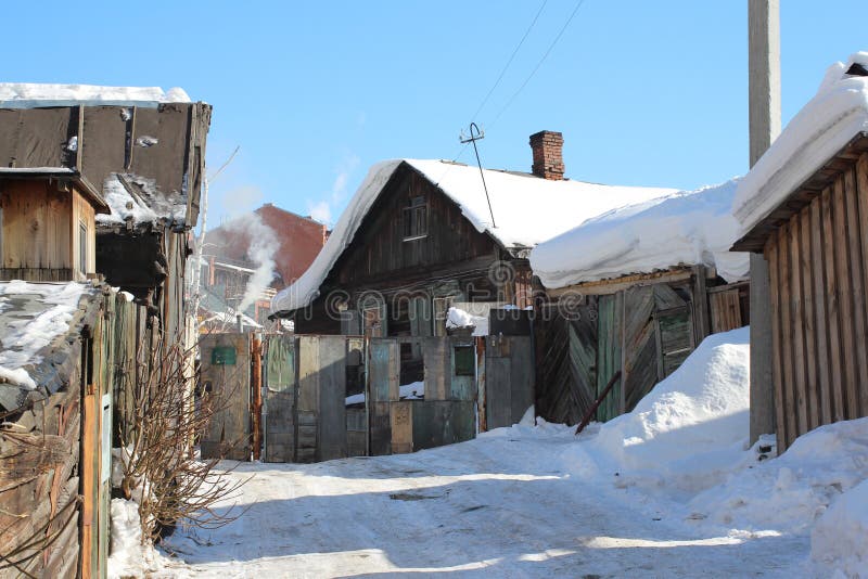 Old wooden village house with outbuildings in the winter. In Russia stock image