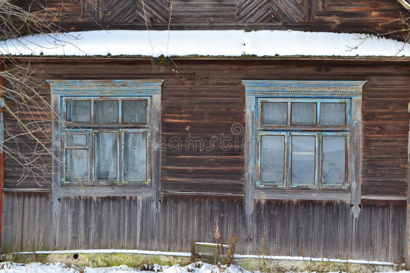 An old wooden window in russian style on a log wall. Traditional old house stock photos