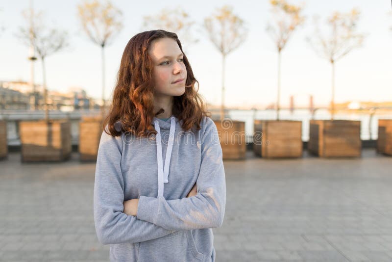 Outdoor portrait of a beautiful smiling teenager girl 14, 15 years old, golden hour.  royalty free stock photography