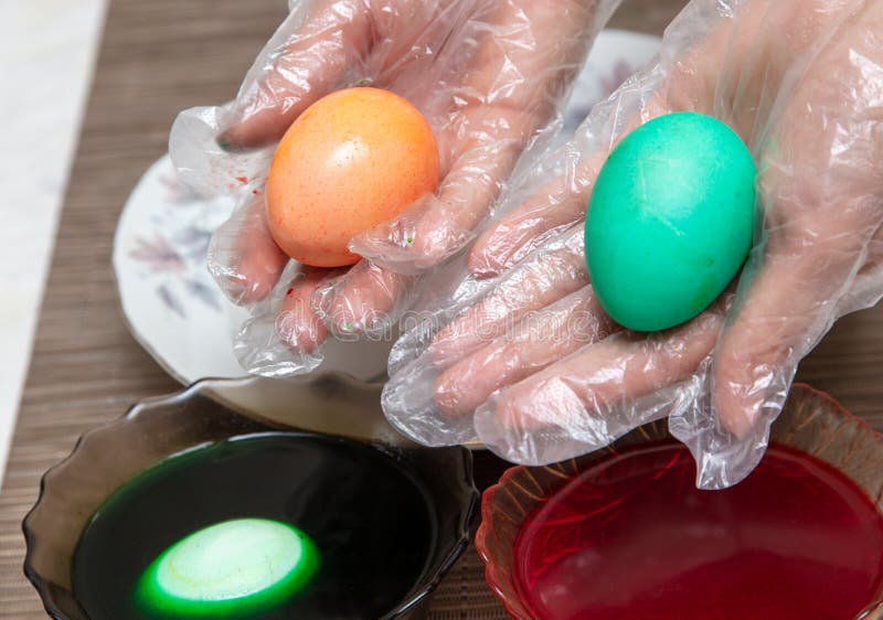Painting eggs in the kitchen. Orthodox Easter holiday stock photography