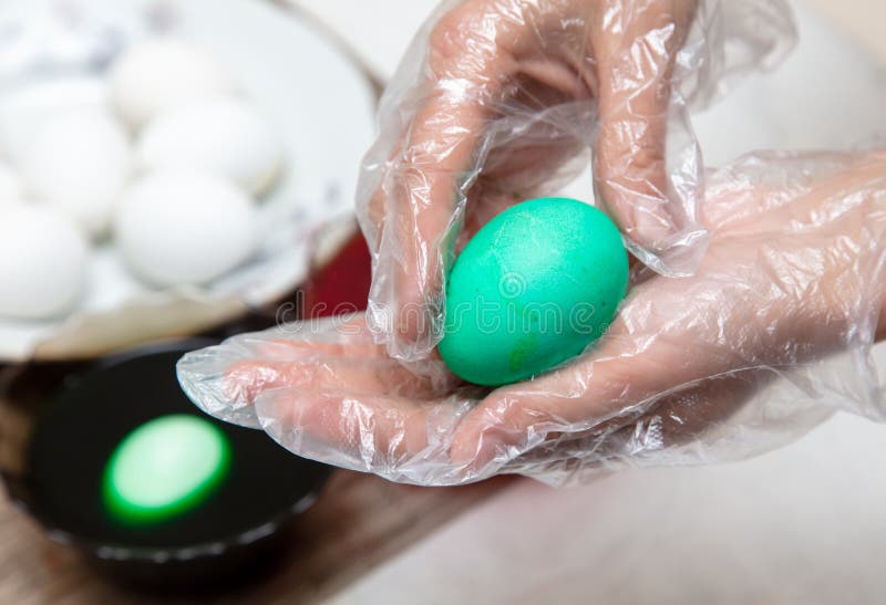 Painting eggs in the kitchen. Orthodox Easter holiday royalty free stock photography