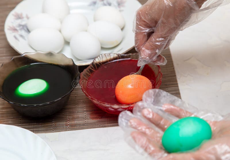 Painting eggs in the kitchen. Orthodox Easter holiday royalty free stock image