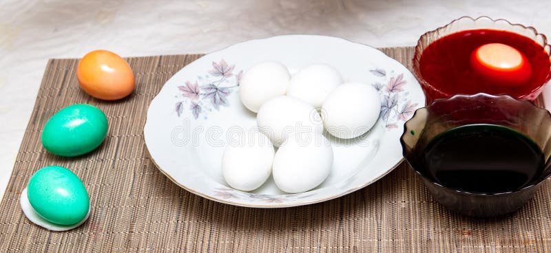 Painting eggs in the kitchen. Orthodox Easter holiday stock photos