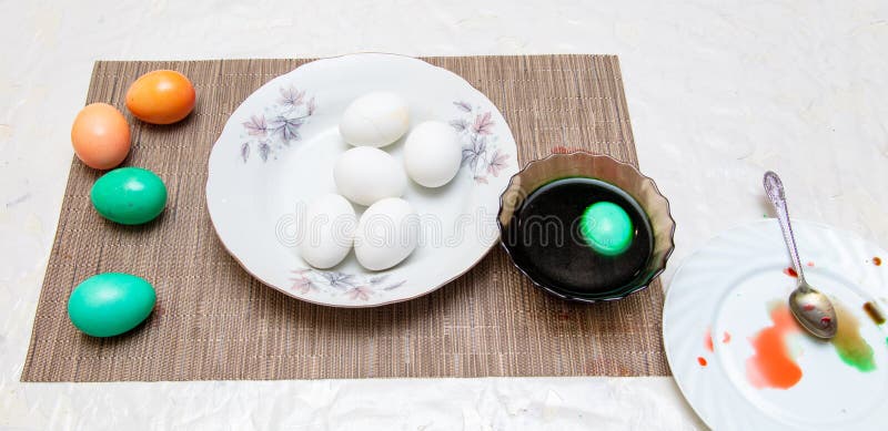 Painting eggs in the kitchen. Orthodox Easter holiday stock photo