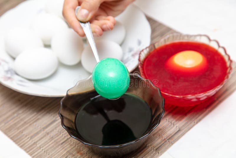 Painting eggs in the kitchen. Orthodox Easter holiday royalty free stock photo