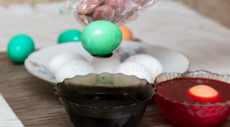 Painting eggs in the kitchen. Orthodox Easter holiday royalty free stock image