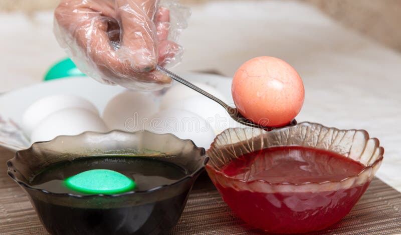 Painting eggs in the kitchen. Orthodox Easter holiday stock images