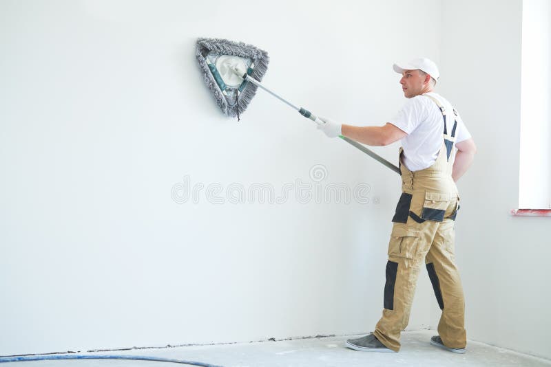Painter works with triangle drywall cleaning tool. Surface preparation for painting. Painting preparation at home impovement. Painter cleaning drywall after stock images