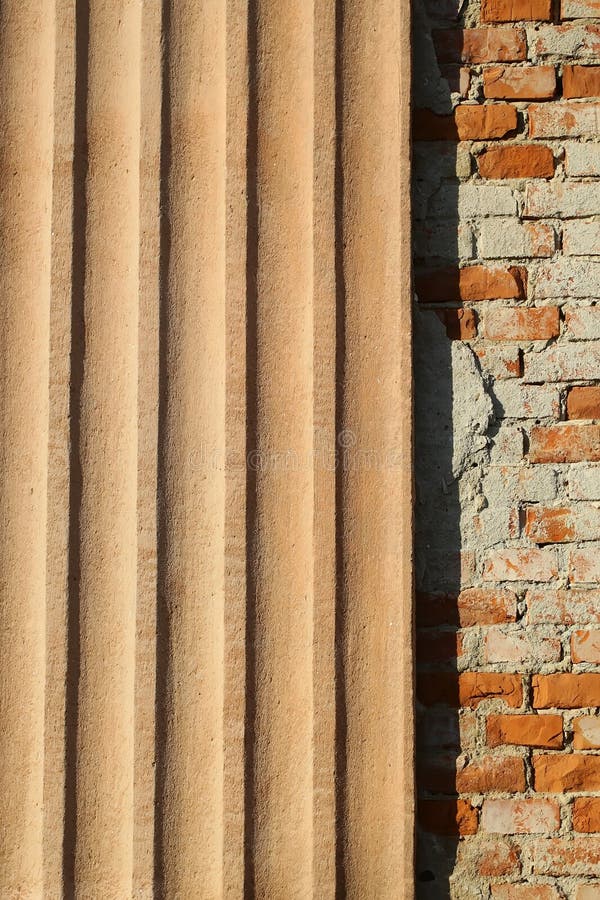 Plastered ribbed and bricks facade. Photo closeup outdoor wall made of warm plastered terracotta colored ribbed finish plate panel and brown sandy bricks facade royalty free stock image