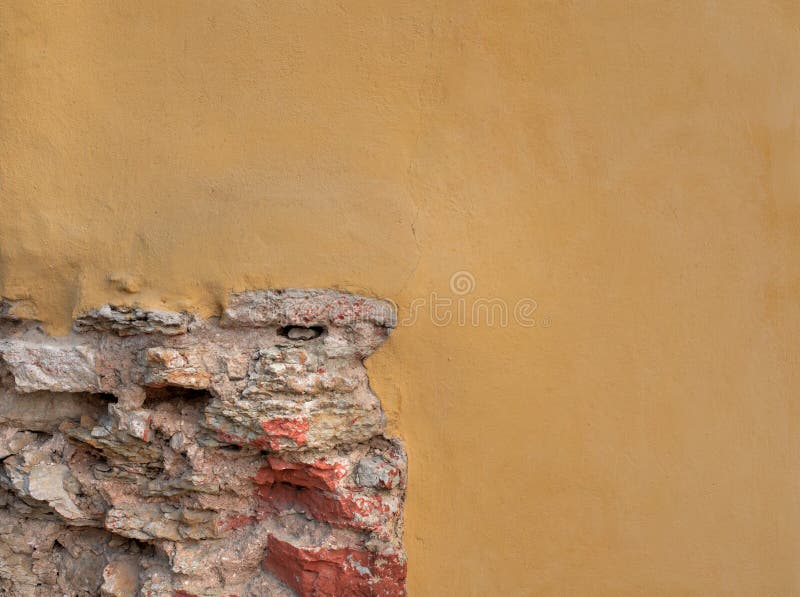 Plastered yellow wall witk brick. Classic facade. Plastered yellow wall. Classic facade. Beautiful background stock photo