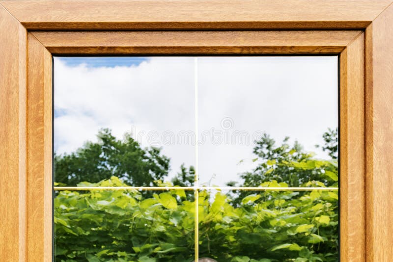 Plastic laminated Windows with partitions in double-glazed Windows. A fragment of a plastic laminated window with partitions in mirrored double-glazed Windows royalty free stock images