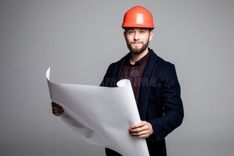 Portrait of an architect builder studying layout plan of the rooms, serious civil engineer working with documents on construction royalty free stock photography