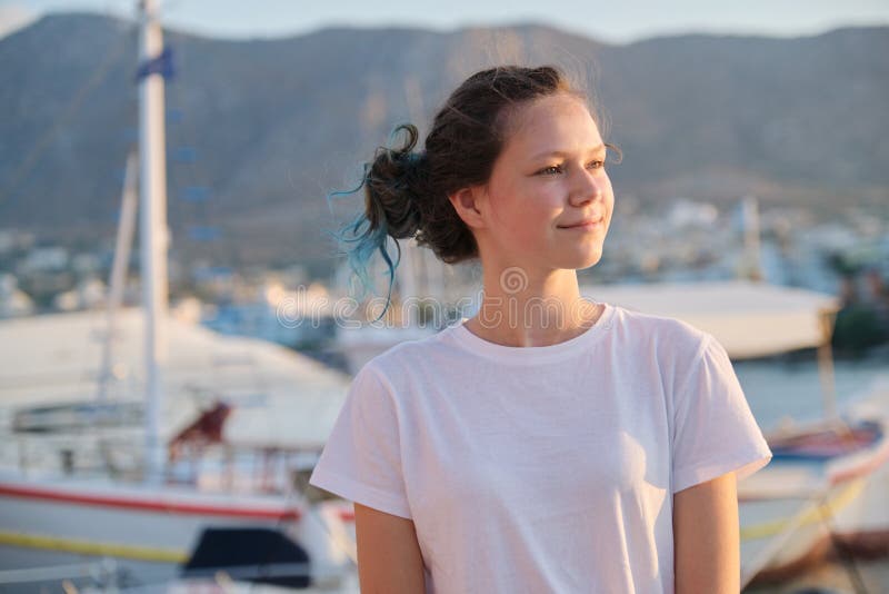 Portrait of teenage girl 15 years old, happy smiling teenager. Summer sunset sea harbor with yachts background. Vacation, adolescence, travel concept stock image